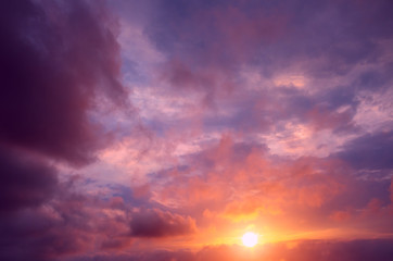 An unusual pink-violet sunset against the background of thunderclouds.