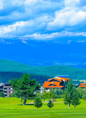 Villas in Balkans Mountains, Europe, Bulgaria. Luxury hotels houses at the Pirin Golf village, summertime, mountains and gold course on the background.