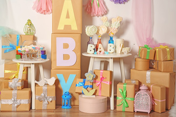 Composition with baby shower decorations and gifts indoors