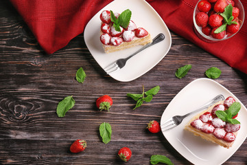 Composition with delicious cake, strawberries and mint on wooden background