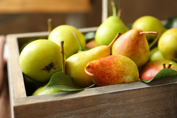 Ripe pears in wooden basket