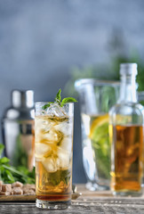 Long glass with mint julep on kitchen table