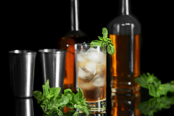 Glass with mint julep on blurred background