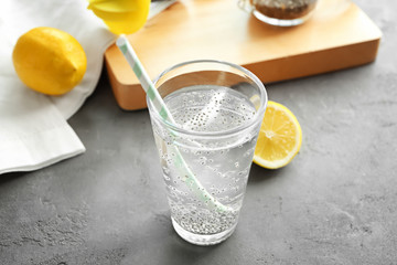 Chia seeds in glass of water on kitchen table