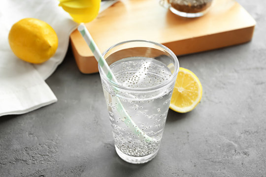 Chia seeds in glass of water on kitchen table