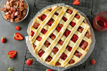 Delicious strawberry rhubarb pie on table