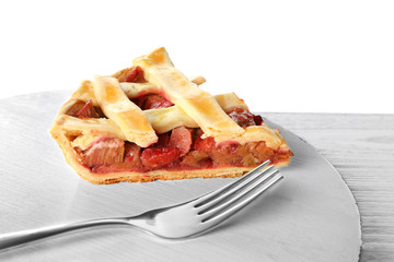 Board with piece of tasty strawberry rhubarb pie on table