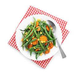 Plate with delicious green beans, corn and carrot slices on white background