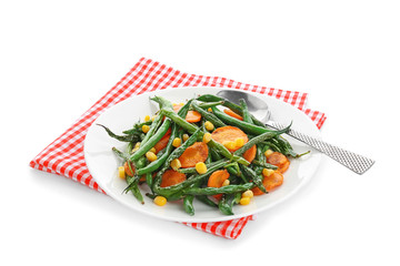 Plate with delicious green beans, corn and carrot slices on white background
