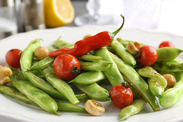Plate with delicious green beans, mushrooms and cherry tomatoes, closeup