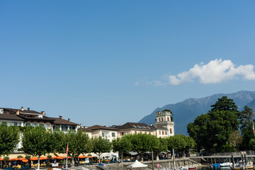city view of locarno from lago maggiore with blue sky and water