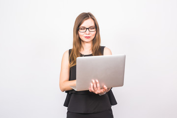 Naklejka premium business, technology and people concept - businesswoman with laptop on white background
