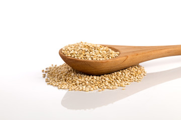 Pile of grain quinoa seeds in spoon