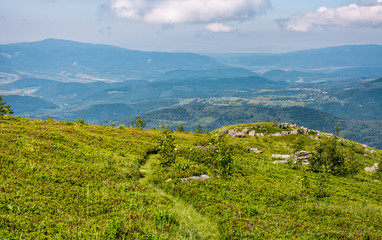 grassy hillside with huge boulders