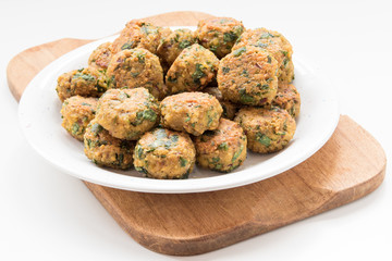 falafel balls on plate and wooden board