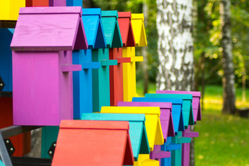 Beautiful multi-colored birdhouses in the Park. High-rise birdhouse