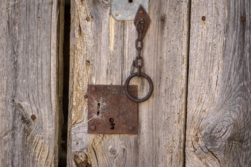 Closeup vintage door lock of external antique wooden door weathered on a Country house