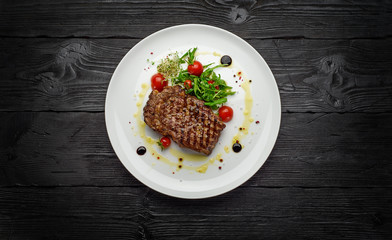 Marble stake with spicy herbs and sea salt over dark wooden background