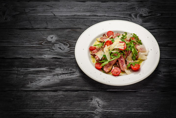 Parmesan with veal rucola and spicy oils