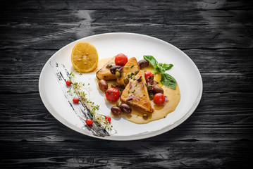 Swordfish fillet prepared by the Sicilian recipe. Decorated with goji.