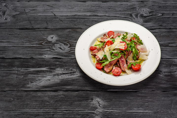 Parmesan with veal rucola and spicy oils