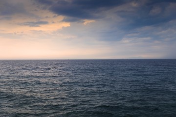 Calm seawater after storm with bright sky