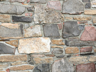 Stonework in rows with mortar in many colors