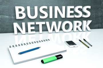 Business Network - text concept with chalkboard, notebook, pens and mobile phone. 3D render illustration.