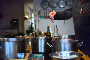 Chef is cooking in the kitchen of a restaurant.
