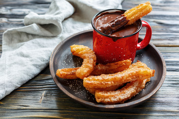 Churros with sugar and cinnamon and hot chocolate.