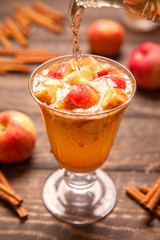 Apple cider cocktail with cinnamon and apple