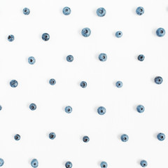 Blueberries on white background. Food blog or magazine concept texture.