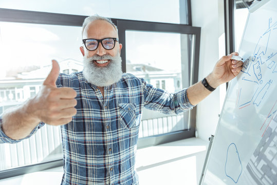 Positive old male in glasses is expressing happiness