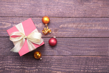 Christmas decorations with gift boxes, tree and balls on wooden background.