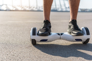 Man legs riding on gyroscope outdoor