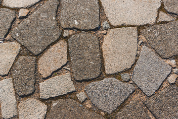 Paving blocks made of asymmetrical granite stone. The stone pavement as the background texture