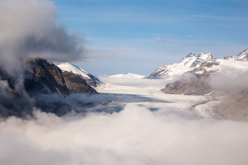 Fototapeta na wymiar Salmon Glacier peeking through early morning fog.