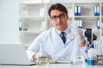 Young researcher scientist doing a water test contamination expe