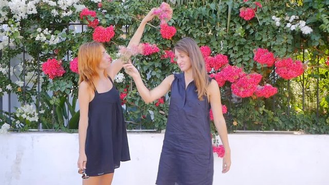 Pretty smiling and dansing women on the street