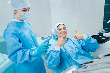 Dentist using surgical pliers to remove a decaying tooth. Modern dental clinic