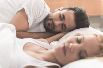 Happy loving couple napping in bedroom