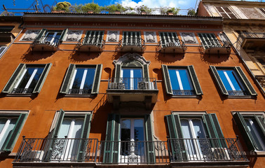 Fototapeta na wymiar Facade of traditional colorful european italian apartment building in Rome , Italy.