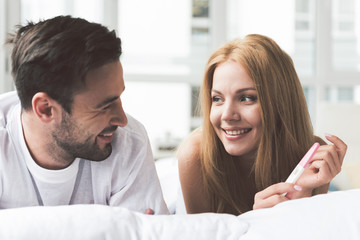 Happy woman telling man about her expectant position