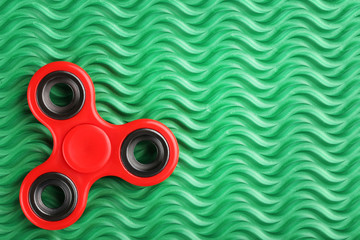 Fidget spinner toy on green background