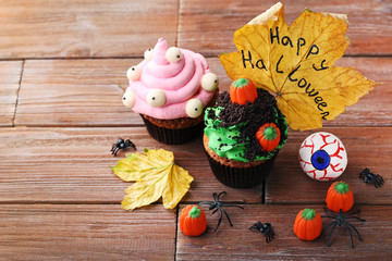 Halloween cupcakes with spiders on brown wooden table