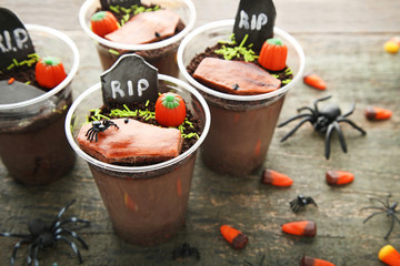 Fresh halloween gingerbread cookies with candies on wooden table