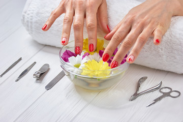 Obraz na płótnie Canvas Spa treatment for female hands. Gentle female hands with beautiful romantic manicure receiving spa treatment in beauty salon. Nails and skin salon care.