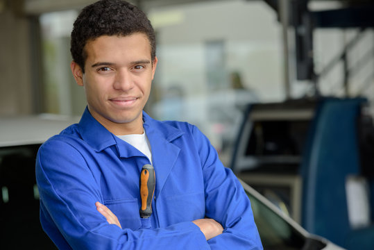 portrait of a male car mechanic standing in the workshop