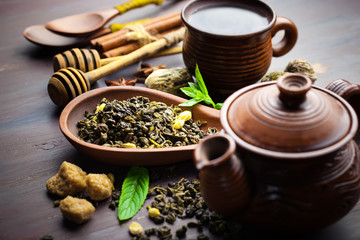 Dry tea leaves in a spoon on an old background