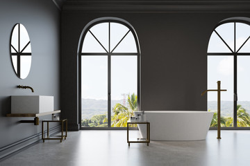 Black bathroom, white marble tub and sink